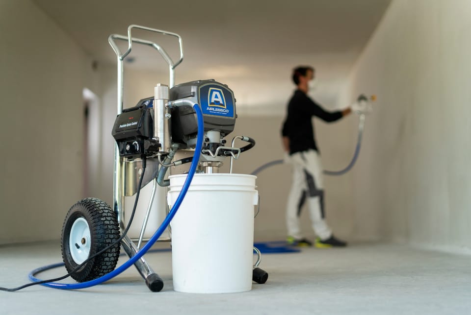 interior being painted with an airless spray system