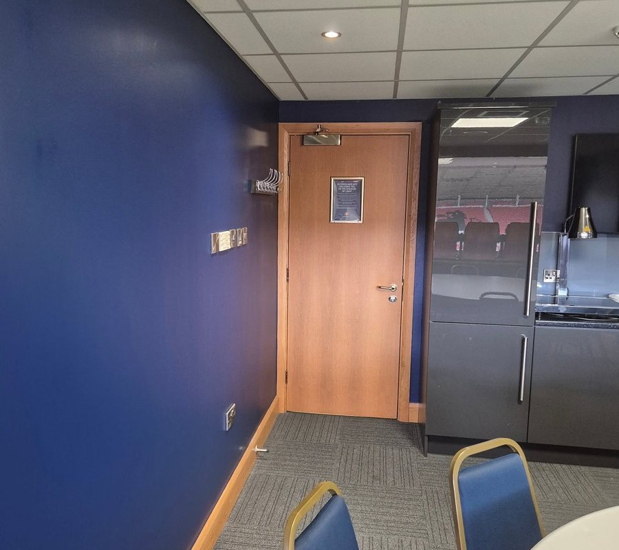 Freshly painted navy walls in a commercial hospitality suite
