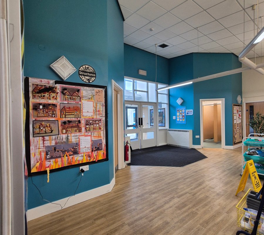 School entrance decorated in teal with white woodwork