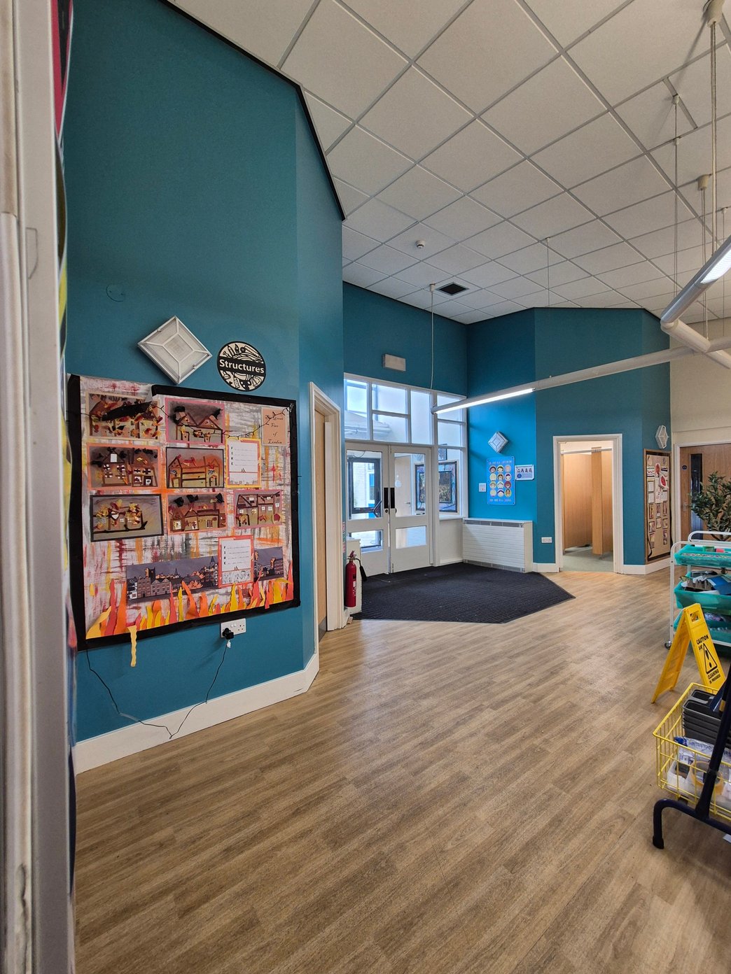 Freshly decorated school entrance with teal walls and white woodwork