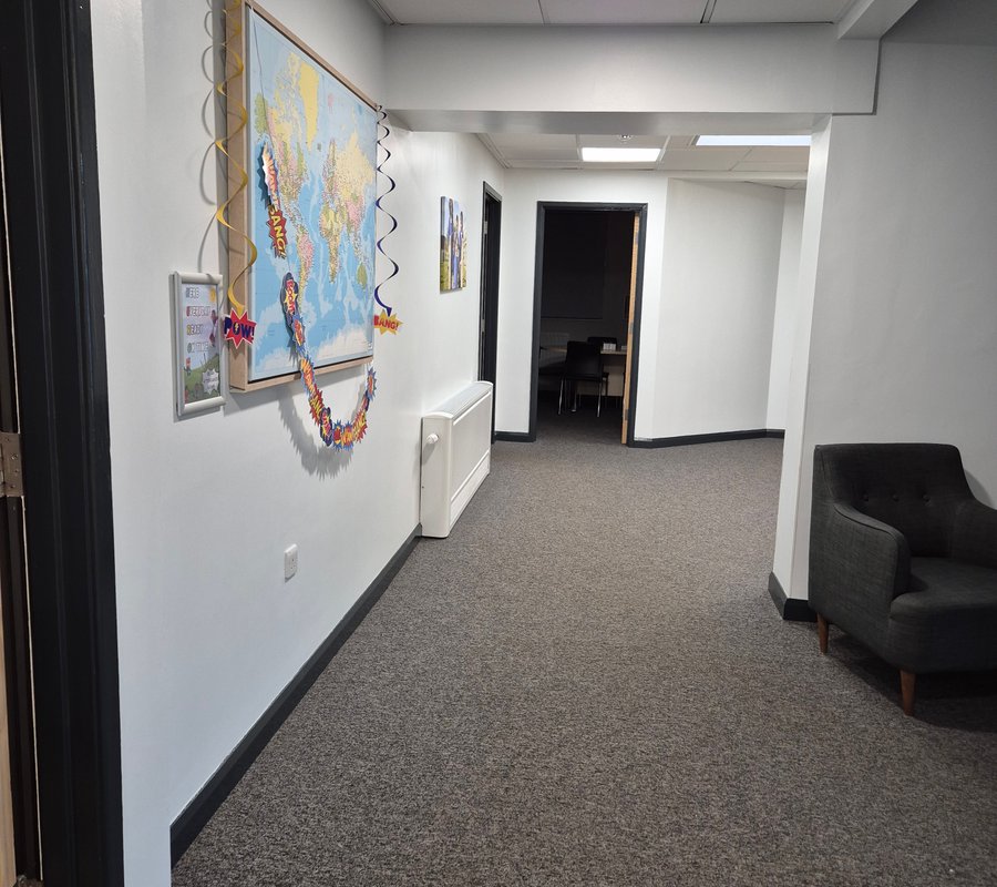 Commercial corridor finished with white walls and dark trim
