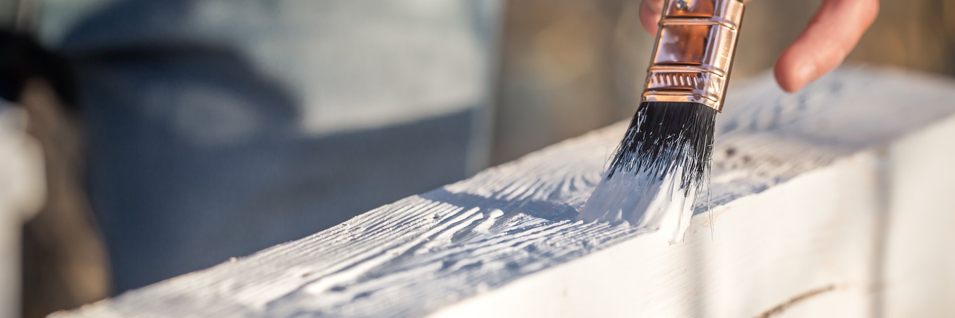 Close-up of a decorator applying paint to woodwork