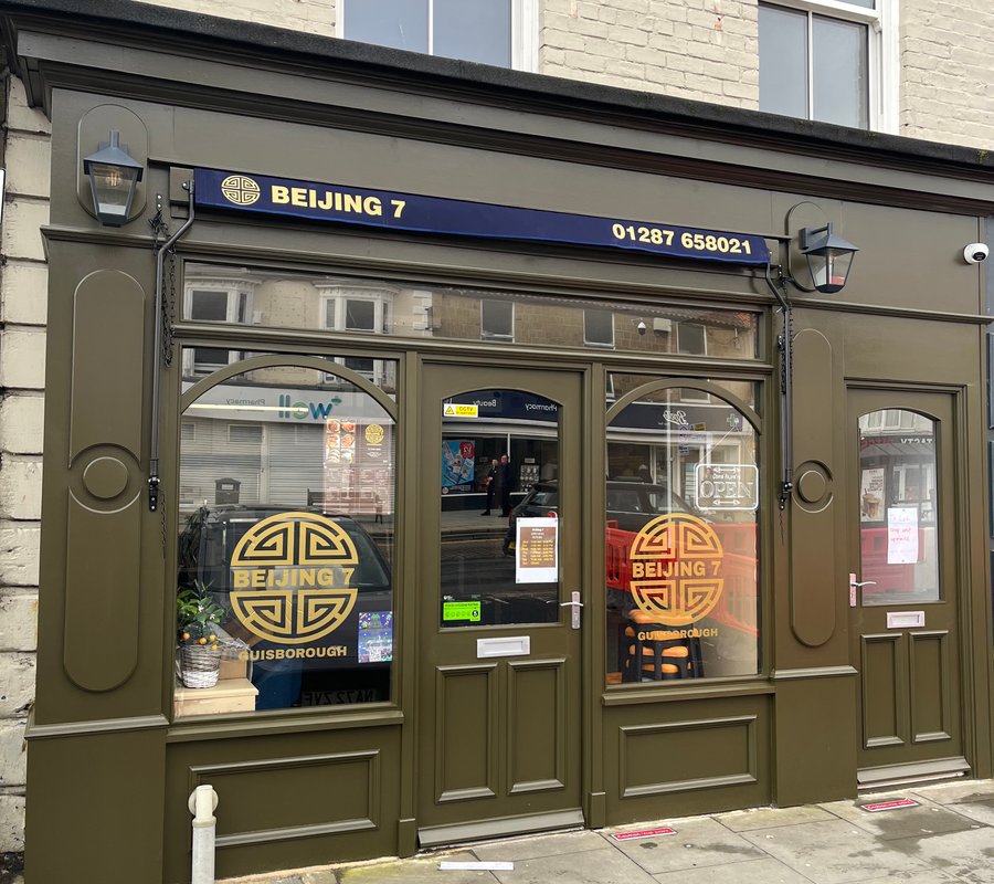 Freshly painted green and cream restaurant shopfront