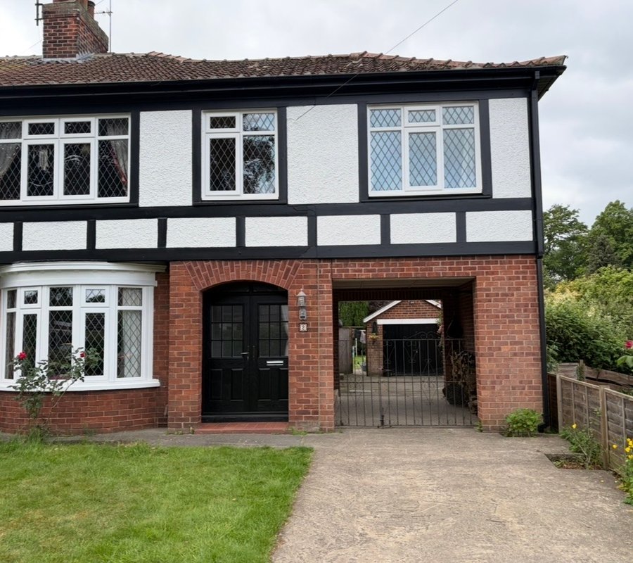 Black and white painted Tudor-style house exterior