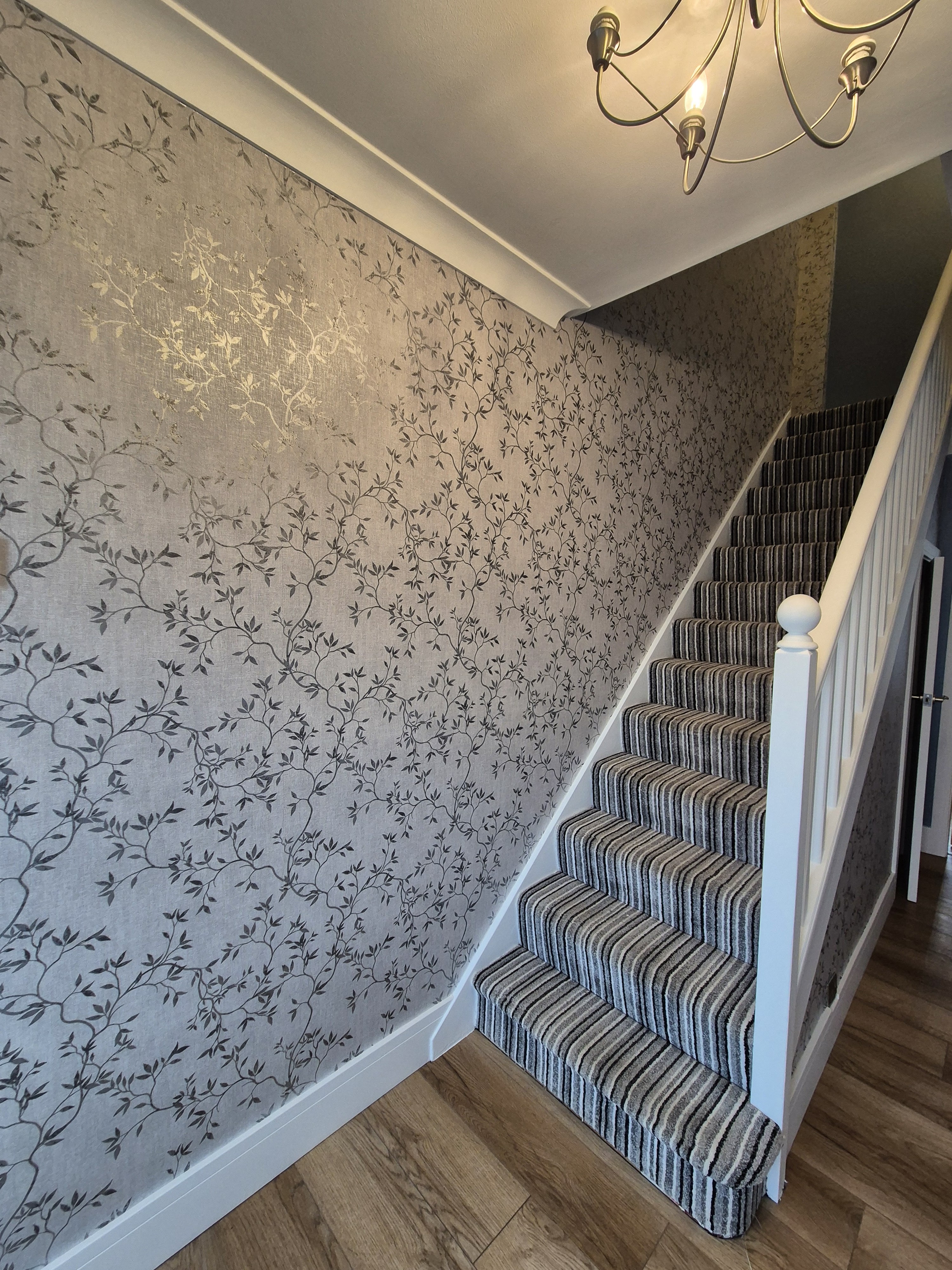 botanical wallpapered hallway and staircase