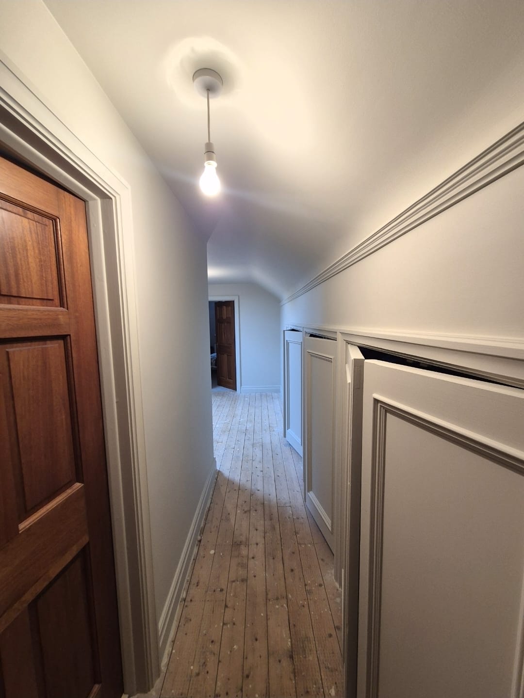 freshly decorated hallway with detailed wall panelling