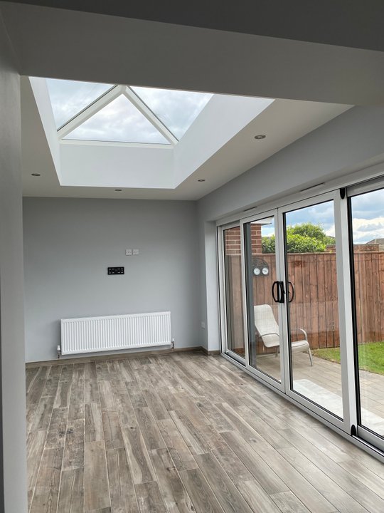 Freshly painted grey extension with white trim and roof lantern