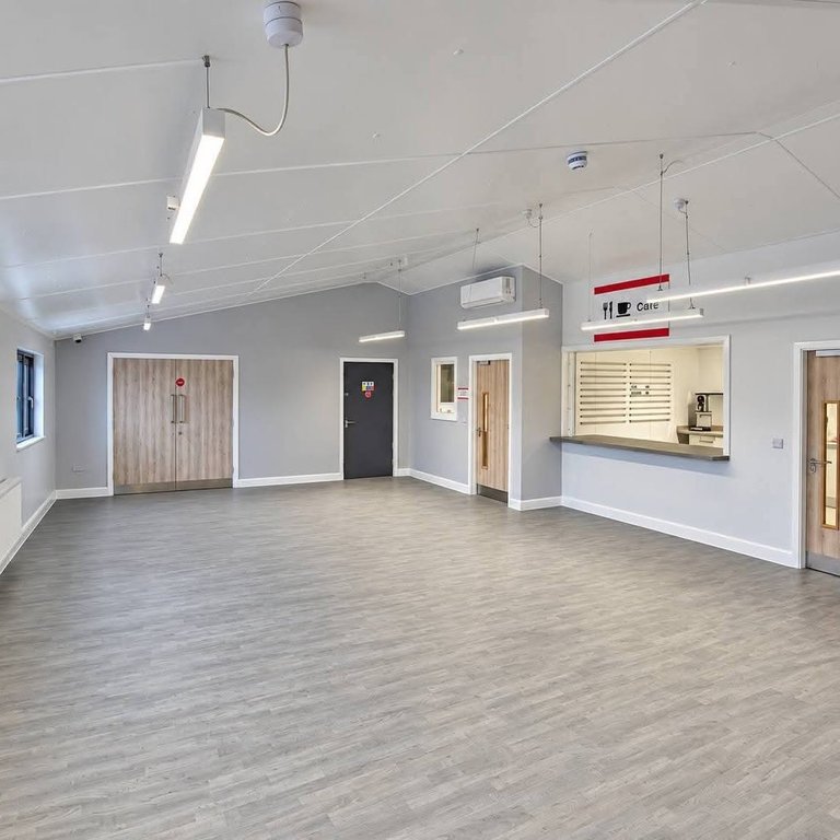 Decorated main hall at Middlesbrough FC Foundation East Cleveland with grey walls, white ceiling and café serving hatch